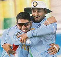 Yuvraj Singh (left) celebrates with Harbhajan Singh after the fall of a Dutch wicket during a warm-up match in Trelawny on Tuesday. 