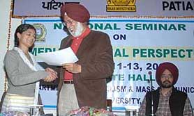 Vice-chancellor of Punjabi University Swarn Singh Boparai gives away a certificate to one of the winners of a workshop on photo journalism at a national seminar at the university on Monday.