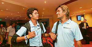 S. Sreesanth (left) talks to Mahendra Singh Dhoni on the Indian team�s arrival at the Hilton Hotel in Port of Spain, Trinidad and Tobago