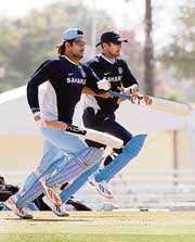 Mahendra Singh Dhoni (left) and Rahul Dravid during a training session at the Sir Frank Worell Ground at the University of West Indies in Port of Spain (Trinidad and Tobago) on Tuesday. 