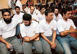 Pakistan cricket team members listen to Inzamam-ul-Haq announcing his retirement from one-day cricket during a press conference in Kingston on Sunday. 