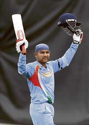 irendra Sehwag raises his bat after his century