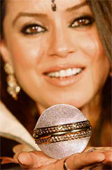 Bollywood actress Mahima Choudhary displays one of the two diamond-studded cricket balls at a function in Mumbai.