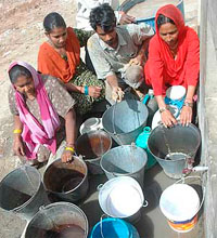 Residents of Patiala wait for their turn at a municipal corporation water tap in Abhlonwal, Patiala, on the eve of World Water Day