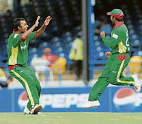 Bangladesh�s Syed Rasel (left) celebrates with team-mate Aftab Ahmed after the dismissal of Bermudan batsman David Hemp at the Queen�s Park Oval in Port of Spain on Sunday.