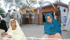 35-year-old Gurmeet Kaur waits for the body of her husband Raj Singh who committed suicide in the Central Jail, Patiala