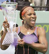 Serena Williams of the US holds the trophy after winning her final match against Justine Henin of Belgium at the Sony Ericsson Open in Miami, on Saturday. Serena won 0-6, 7-5, 6-3.