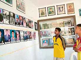 Budding hockey players look at the photographs of former players at the motivation hall coming up at Sansarpur. 