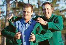 Zach Johnson (left) receives the traditional green blazer from last year�s champion Phil Mickelson after winning the US Masters golf tournament at the Augusta National Golf Club in Georgia.