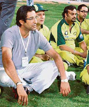 Former Pakistan captain Wasim Akram watches the exhibition match between Indian and Pakistani cricketers and film stars to create awareness about diabetes in Abu Dhabi