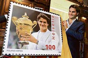 World No. 1 tennis player Roger Federer of Switzerland unveils a giant replica stamp during the launch of a Swiss postage stamp bearing his portrait in Basel