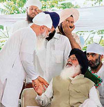 H.S. Hanspal, former PPCC president and accused in the Ludhiana City Centre scam, has a word with Chief Minister Parkash Singh Badal at Bhaini Sahib, near Ludhiana.