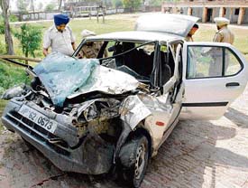 The mangled remains of a car that collided with a bus on the Rajpura-Patiala road on Tuesday. 
