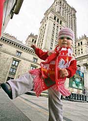 A young Polish football fan celebrates in Warsaw on Wednesday after Poland and Ukraine won the bid to jointly host the Euro 2012 football championships.