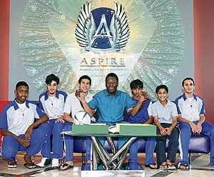 Brazilian football legend Pele poses with students after a press conference at the Aspire Academy of Sports Excellence in Doha on Wednesday. The Qatari sports academy has launched a programme that will provide African students from seven nations with a chance to study and train in one of the world�s most advanced sports academies. 