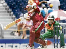 West Indian batsman Ramnaresh Sarwan plays a shot as Bangladesh wicketkeeper Mushfiqur Rahim looks on during the Super Eight match at the Kensington Oval in Bridgetown on Thursday. 