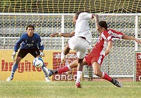 Sporting Clube de Goa�s Ernest Jeremiah takes a shot at the goal as JCT defender Gurwinder Singh attempts to stop him in the 11th National Football League at Ludhiana�s Guru Nanak Stadium