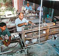 A chemical analyst works in the open at the backyard of the laboratory in Patiala.