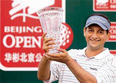 Gaurav Ghei holds the trophy after winning the Pine Valley Beijing Open golf tournament.