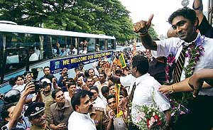 Sri Lanka captain Mahela Jayawardene gestures to fans who braved heavy rain to greet the team on their return to Colombo on Thursday.