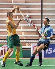 Naylor Mathew of Australia (left) and Sardara Singh of India vie for the ball at the Sultan Azlan Shah hockey tournament in Ipoh, Malaysia, on Saturday. India lost 0-1.