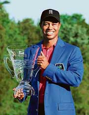 Tiger Woods poses with the winner�s trophy after his victory at the Wachovia championship in Charlotte, North Carolina on Sunday. 