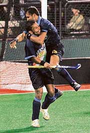 Bharat Chikkara (left) celebrates with Tushar Khandkar after scoring the first goal against Argentina during their Sultan Azlan Shah Cup match in Ipoh on Wednesday. India won 2-0. 