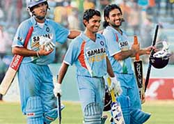 Mahendra Singh Dhoni (right) and Dinesh Karthik return to the pavilion after steering India to victory in the first one-dayer against Bangladesh in Dhaka on Thursday. 