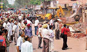 Illegal structures being razed during an anti-encroachment drive on the Amritsar-Pathankot-Kullu road on Tuesday.