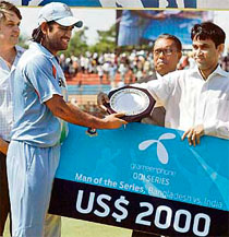 Mahendra Singh Dhoni receives the man-of-the-series award for the Grameenphone ODI series in Chittagong on Tuesday.