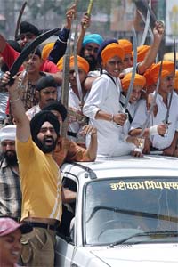 Activists of various radical Sikh groups brandish swords during a protest in Amritsar