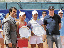 Sania Mirza and Vania King of the US with spoils of victory after they won the doubles title at the Morocco Open at Fes on Saturday.
