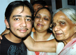 Elated Aditya Aggarwal with his family at his residence in Patiala on Sunday.