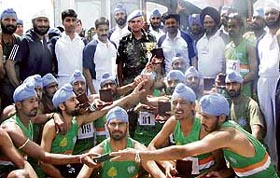 Members of the 15 Punjab Infantry battalion team with Brig-Gen RMA Merino, Sector Commander (centre), after winning the UNIFIL Inter-Contingent Cross-Country Championship Trophy in Lebanon.