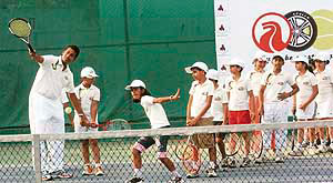 Mahesh Bhupathi gives tennis lessons to children at the Gymkhana Club in New Delhi on Wednesday.