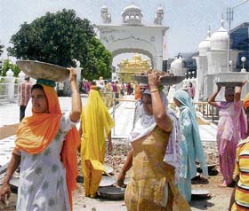 Sikh devotees take part in kar sewa for the construction of a corridor around the Golden Temple in Amritsar