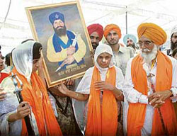 Family members carry a picture of Kanwaljit Singh after the bhog ceremony at Gurdwara Nankiana Sahib in Sangrur on Sunday.