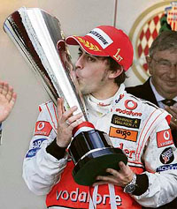McLaren driver Fernando Alonso kisses the trophy after winning the Monaco Formula One Grand Prix in Monte Carlo on Sunday.