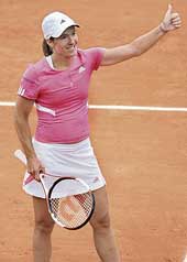 Belgium�s Justine Henin celebrates after beating Russia�s Elena Vesnina in the first round of the French Open in Paris on Sunday. Henin won 6-4, 6-3.
