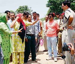 Muslim women from the Gujjar community argue with a policeman at Manwal village in Pathankot on Wednesday.