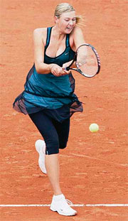 Maria Sharapova of Russia in action against Emilie Loit of France during the first round of the French Open in Paris on Wednesday. Sharapova won 6-3, 7-6.