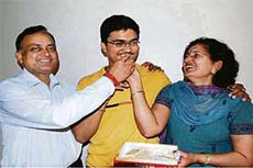 Parents of Vivek Goyal offer him sweets