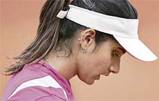 Sania Mirza reacts after losing to Serbia�s Ana Ivanovic at the French Open in Paris on Thursday. Sania lost 1-6, 4-6. 
