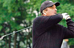 In full swing: Jammu and Kashmir Chief Minister Ghulam Nabi Azad tees off to inaugurate the Inter-State Golf Tournament at the Royal Springs golf course in Srinagar on Sunday.