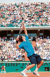 Swiss Roger Federer serves to Mikhail Youzhny of Russia during their fourth-round match at the French Open in Paris on Sunday. Federer won 7-6, 6-4, 6-4.