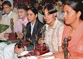 Krishna Punia, Jyotsana, Rajwinder, Navin Kumar and Dinesh Kumar with their Bhim Awards at the Haryana Raj Bhavan in Chandigarh on Wednesday. 