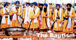 Singh priests prepare amrit at a baptism ceremony in Jammu on Sunday.
