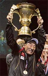 Yo China: Chinese badminton coach Lee Yong Bo (left) lifts the trophy after his team won the Sudirman Cup in Glasgow on Sunday. China beat Indonesia 3-0 in the final.