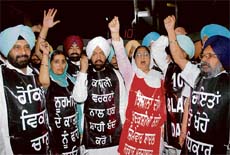 Congress MLAs walk out of the Punjab Vidhan Sabha, in protest against the policies of the SAD-BJP government, in Chandigarh on Wednesday. 