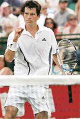 Britain�s Tim Henman celebrates after beating Michael Russell of the US during the Nottingham Open tennis tournament on Tuesday. Henman won 6-1, 7-6.